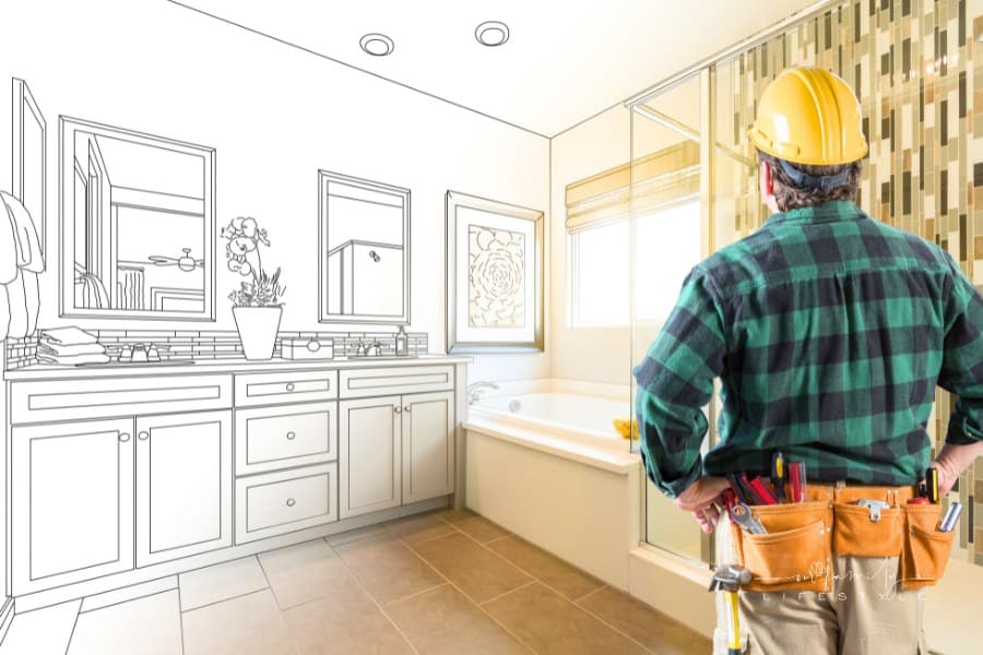 contractor envisioning master bath remodel through blueprints