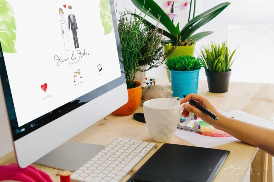 graphic designer using pen tablet to design wedding website