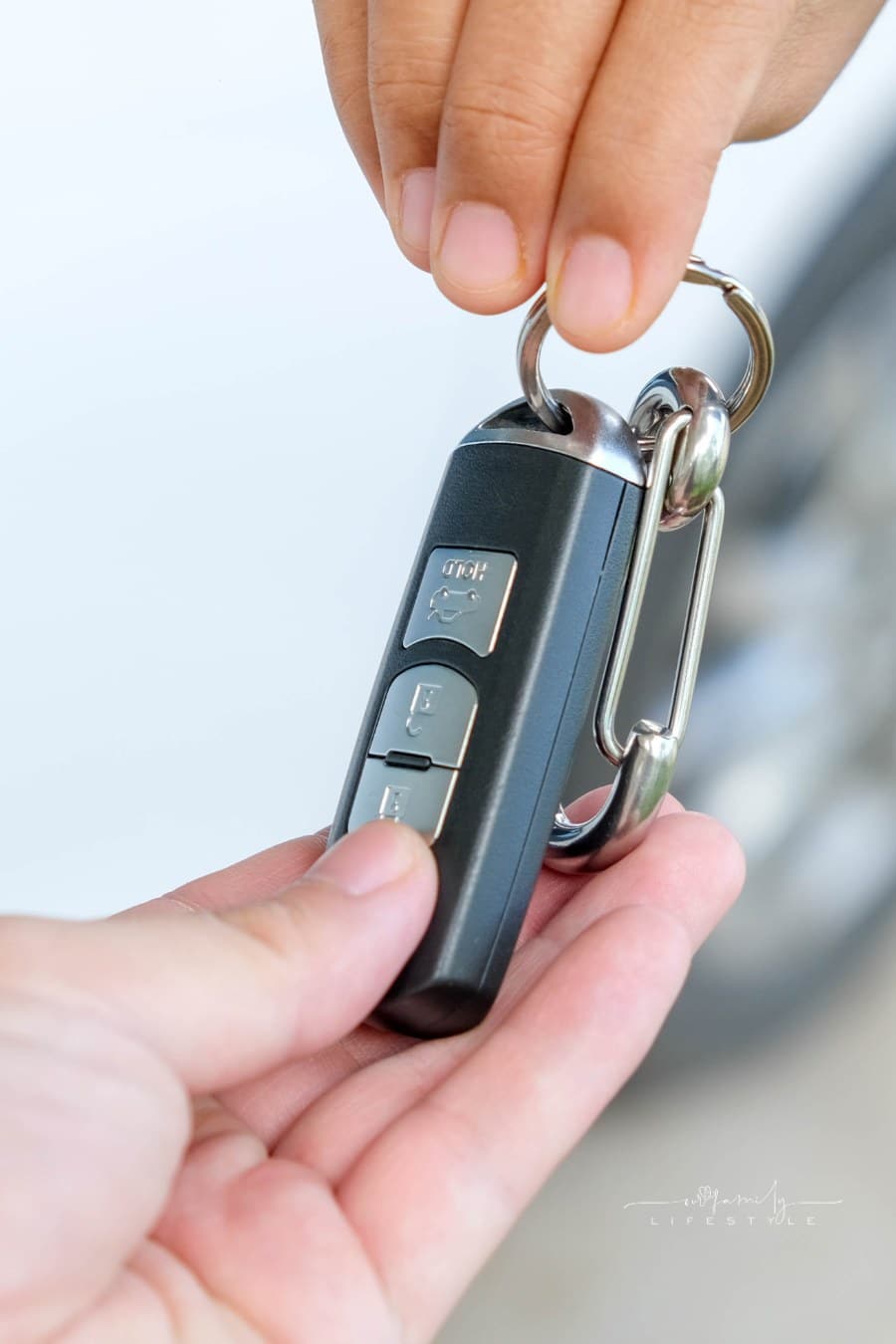 hand giving car keys