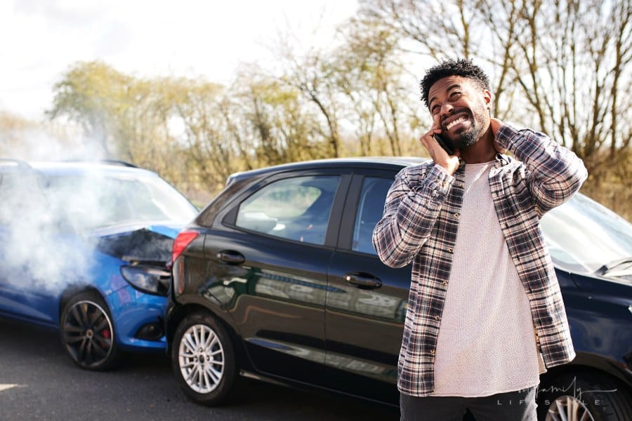 man calling insurance a car accident