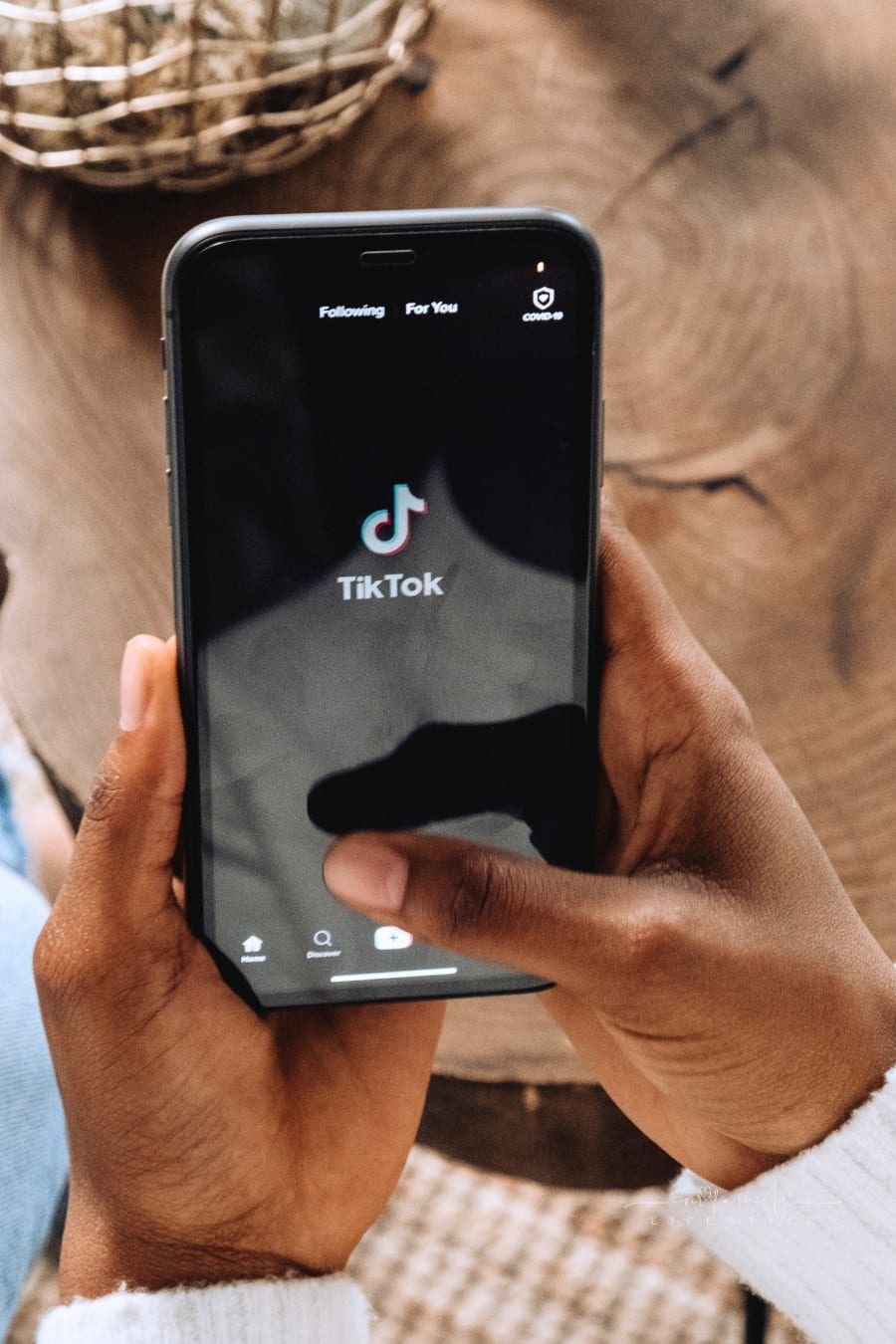 Person Holding Black Smartphone opening TikTok app