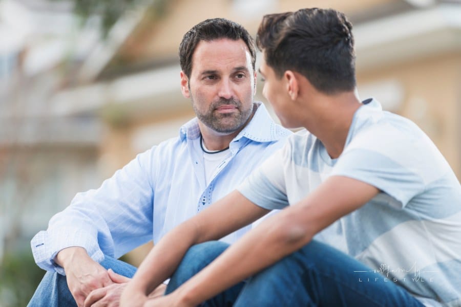 Father having serious conversation with teenage son