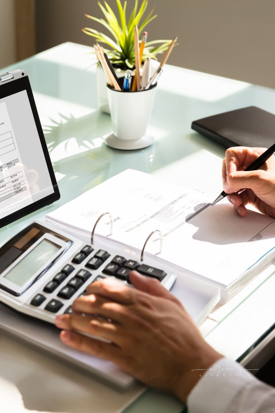 man's hand calculating debt consolidation using calculator