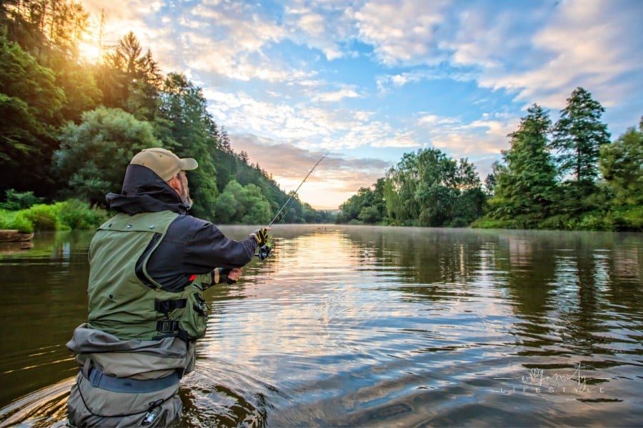 Sport Fisherman Fishing wearing waders in River