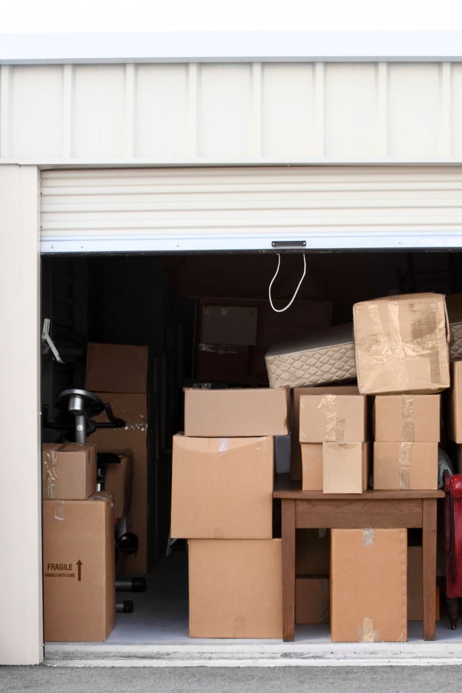 packed moving boxes stacked inside an open self-storage space