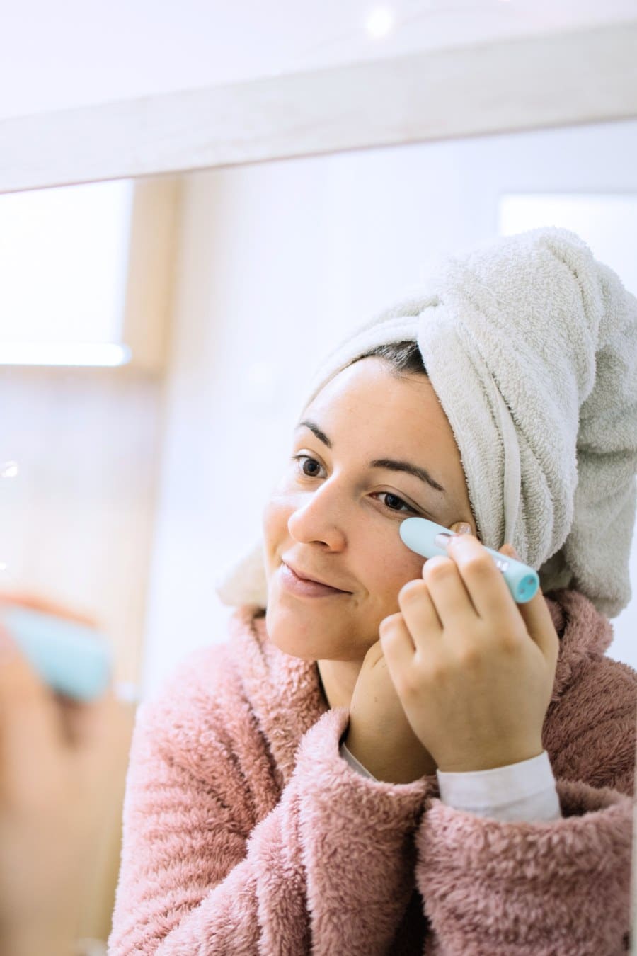 Reflection of a girl using eye wrinkle eraser