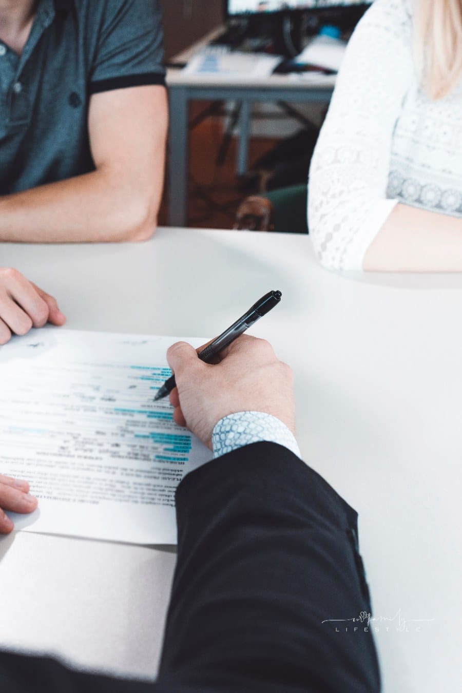 Unhappy young couple at meeting with lawyer about divorce