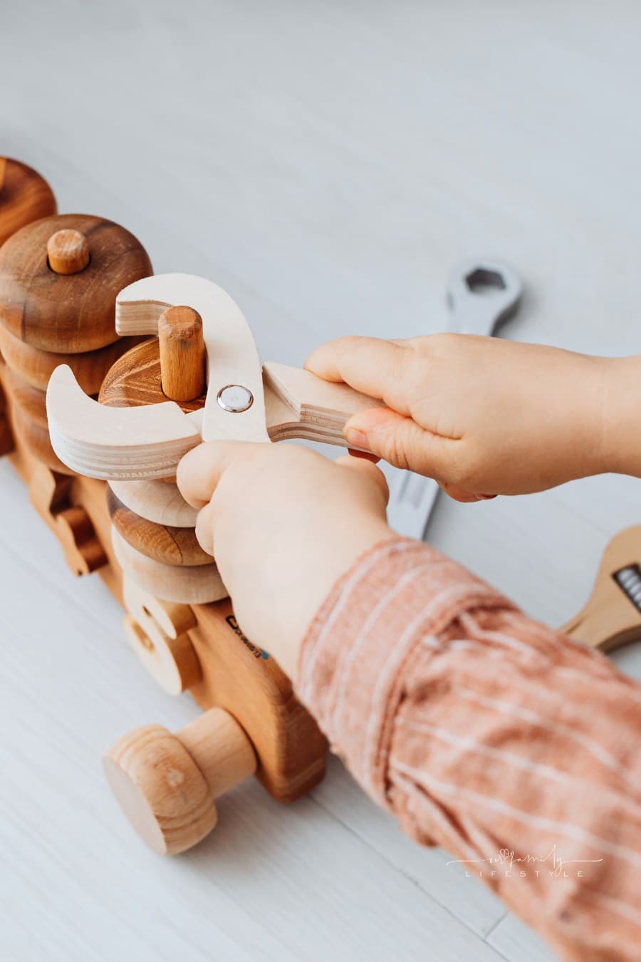 A Kid Playing with Wooden Toys