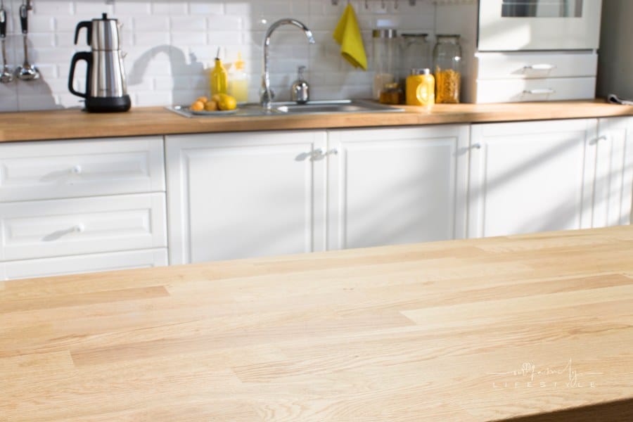 modern kitchen with white cabinets and butcher block countertops