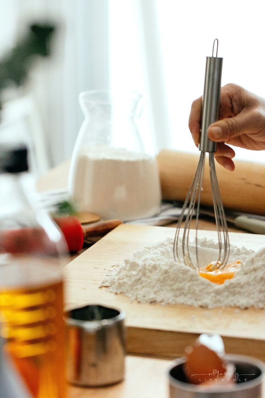 women using whisk for egg and flour in kitchen