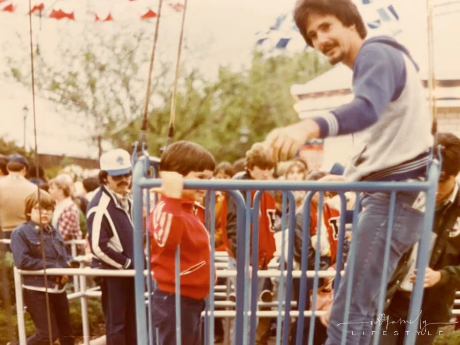vintage photo of old theme park ride with young boy and dad in wire basket
