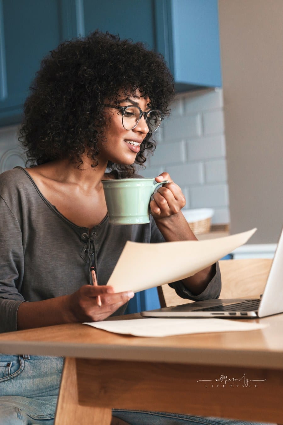 Smiling Young Female Entrepreneur Working on Laptop