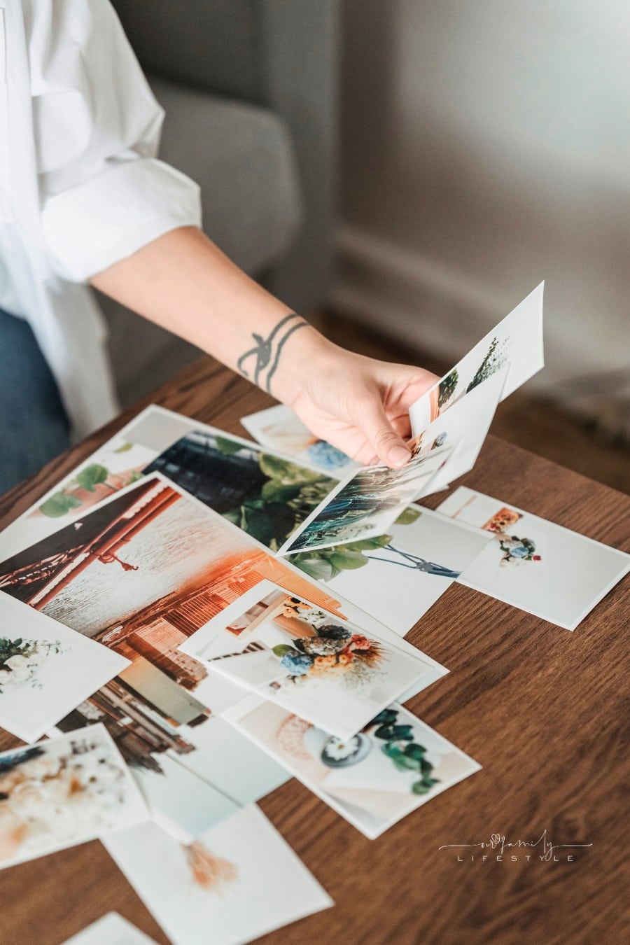 unrecognizable woman looking through printed photos