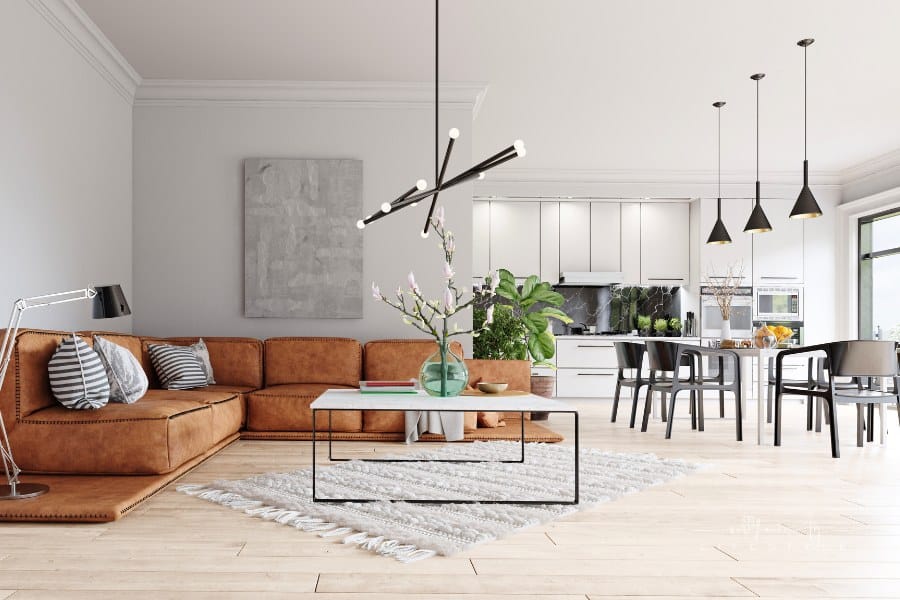 modern living room with natutal light from windows, as well as pendant lights and artisitic chandelier