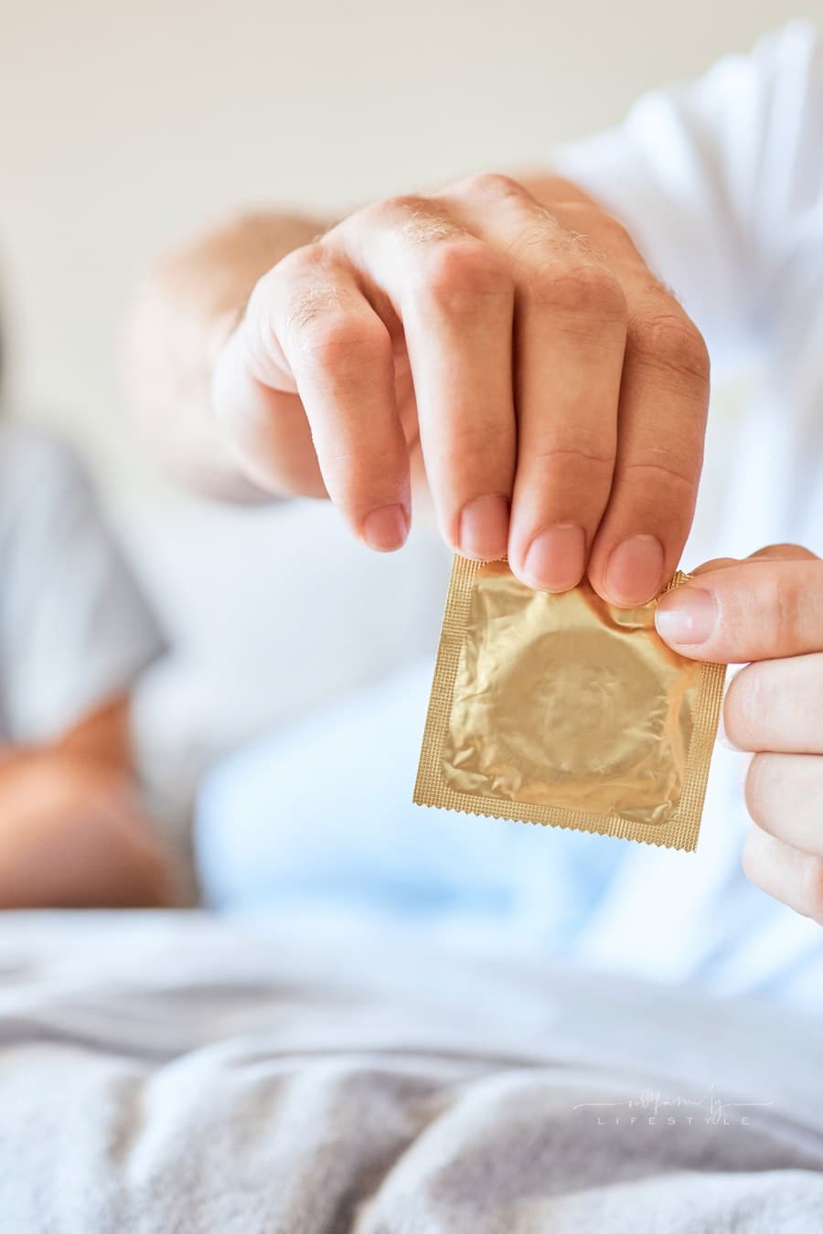 Condom and Safety for Couple in Bed Together Use Protection. Man and Woman Open Birth Control Contraceptive Package to Protect against Std, Sti or Hiv