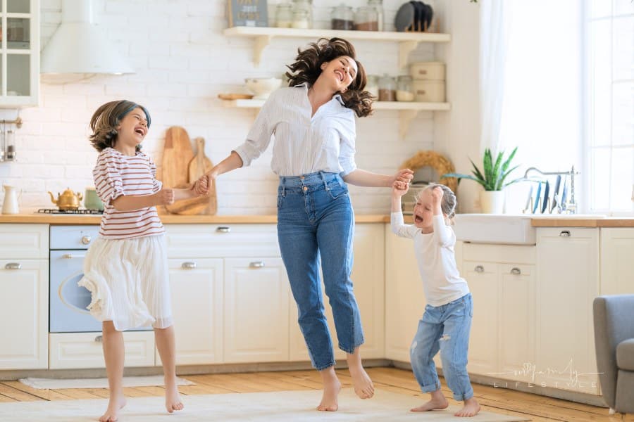 Mom and Her Daughters Are Dancing in the Kitchen
