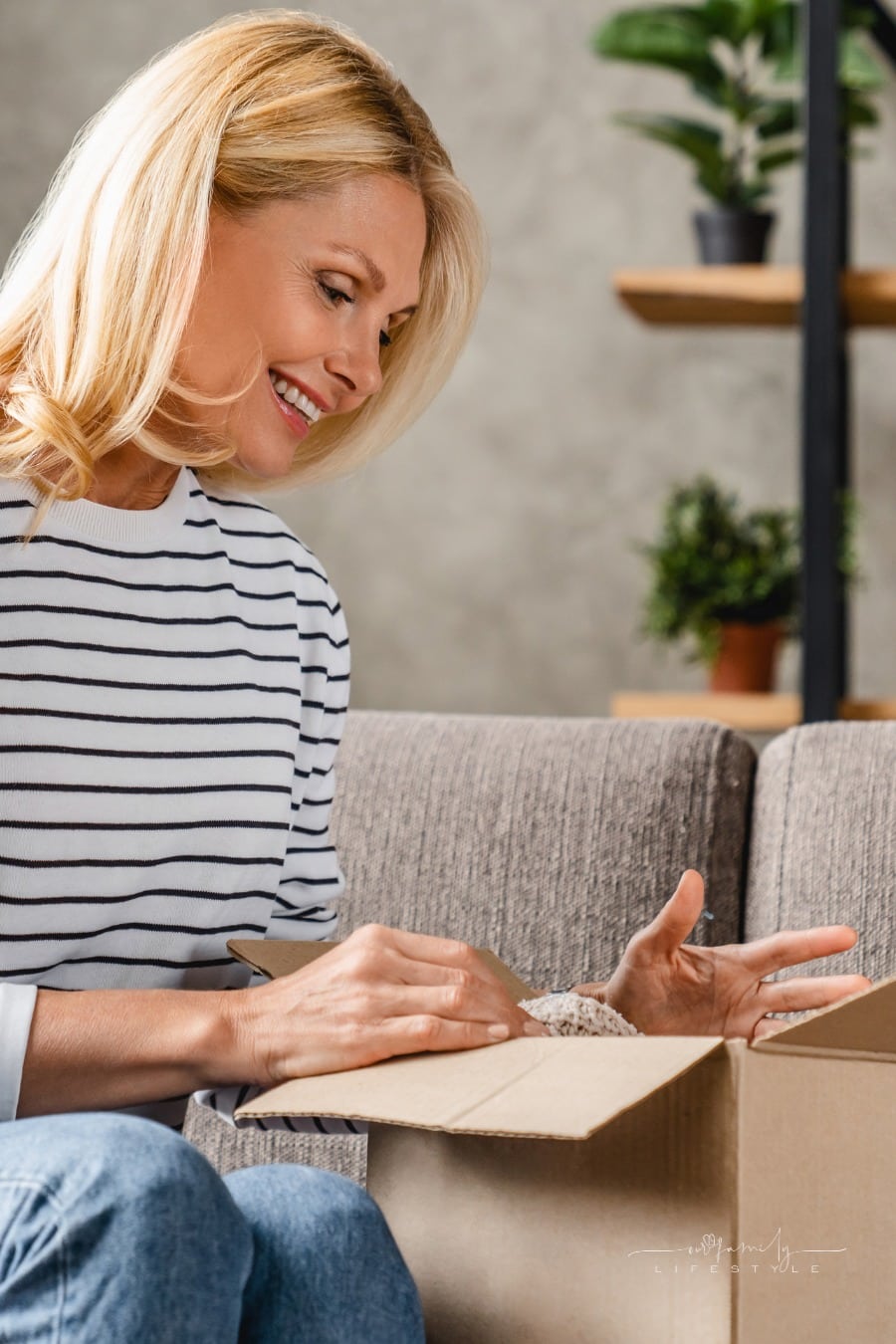 middle age woman packing away things to declutter house