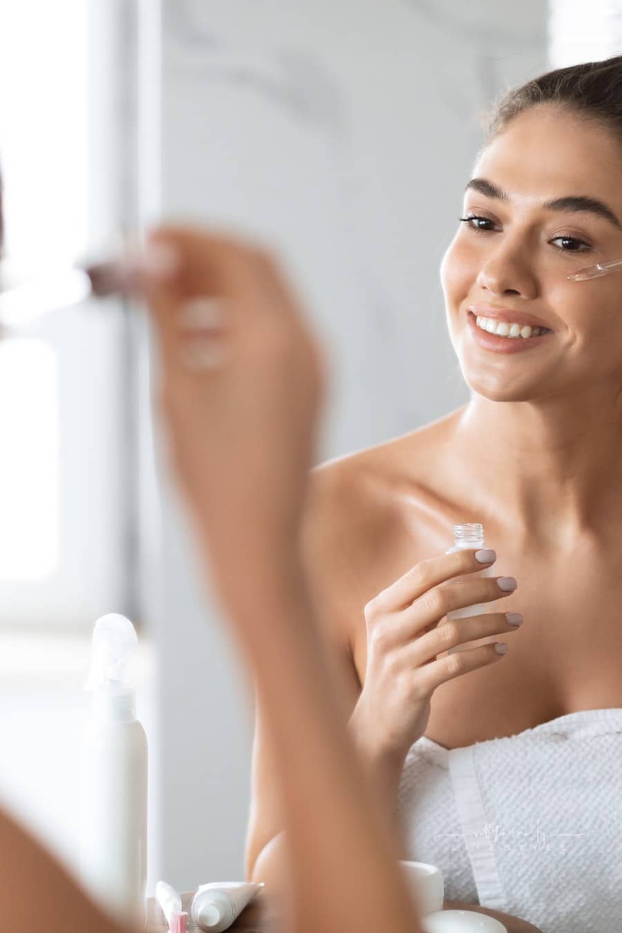 Woman Applying Face Serum Using Dropper Caring For Skin Indoors
