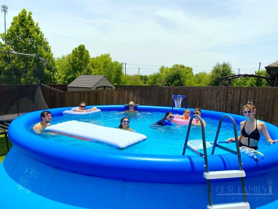 whole family in the backyard pool
