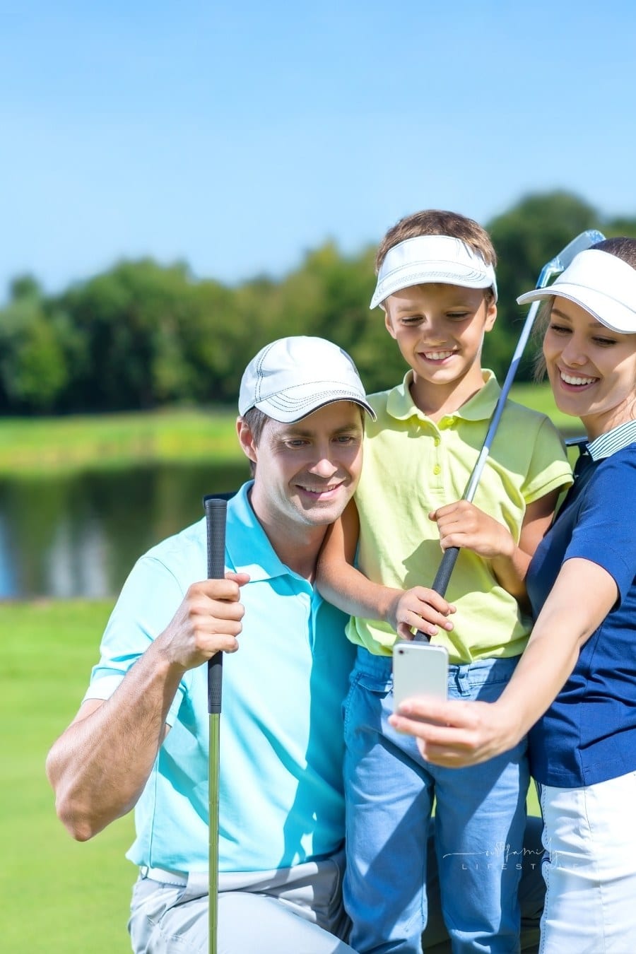 couple with child taking selfie on golf course