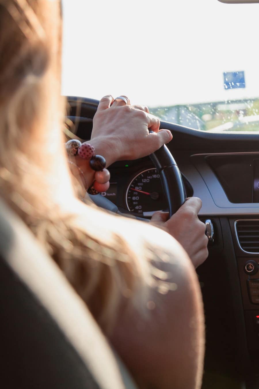 Woman Driving a Car; view from backseat of car