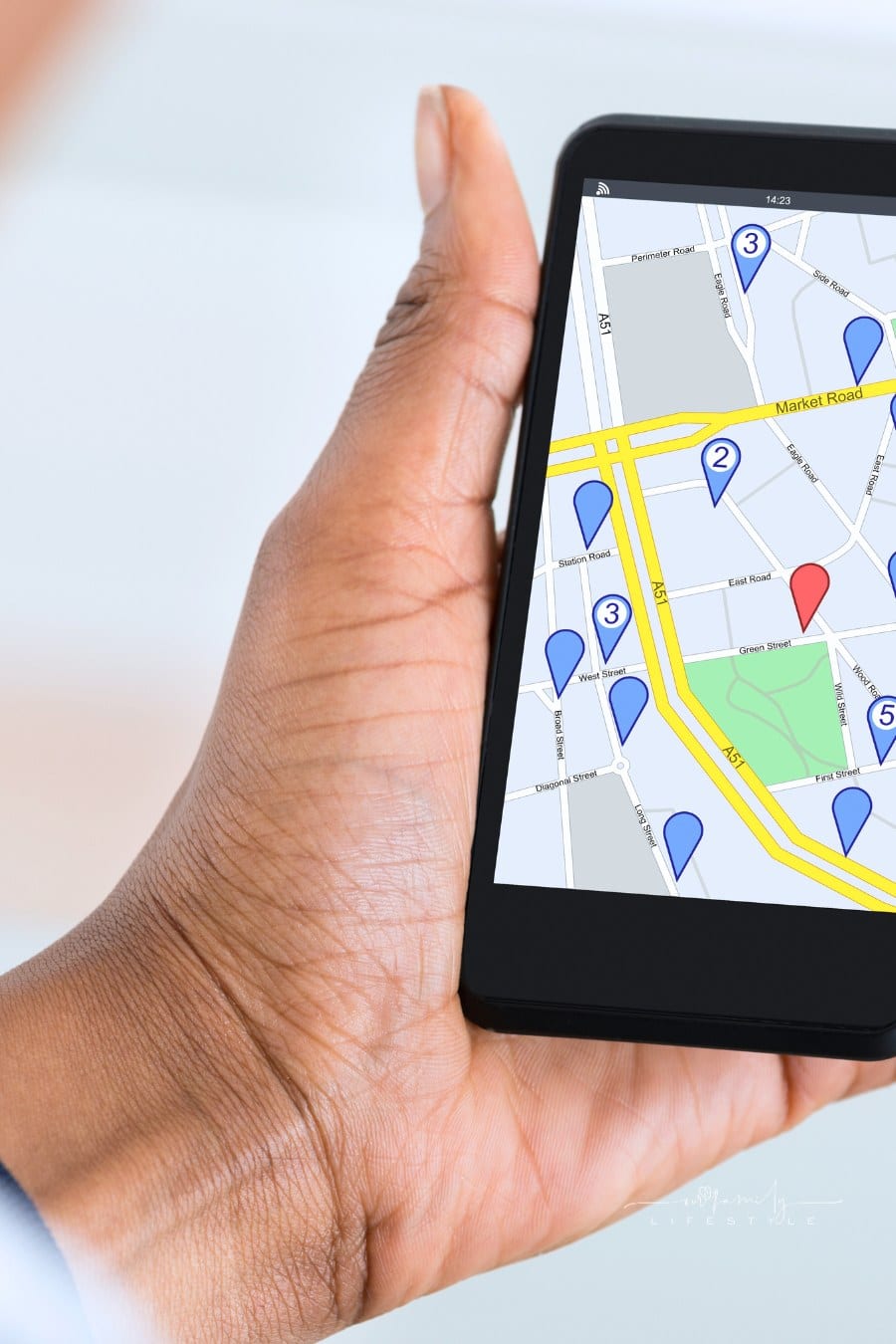 Hand Holding Mobile Phone With Location Mark On Map