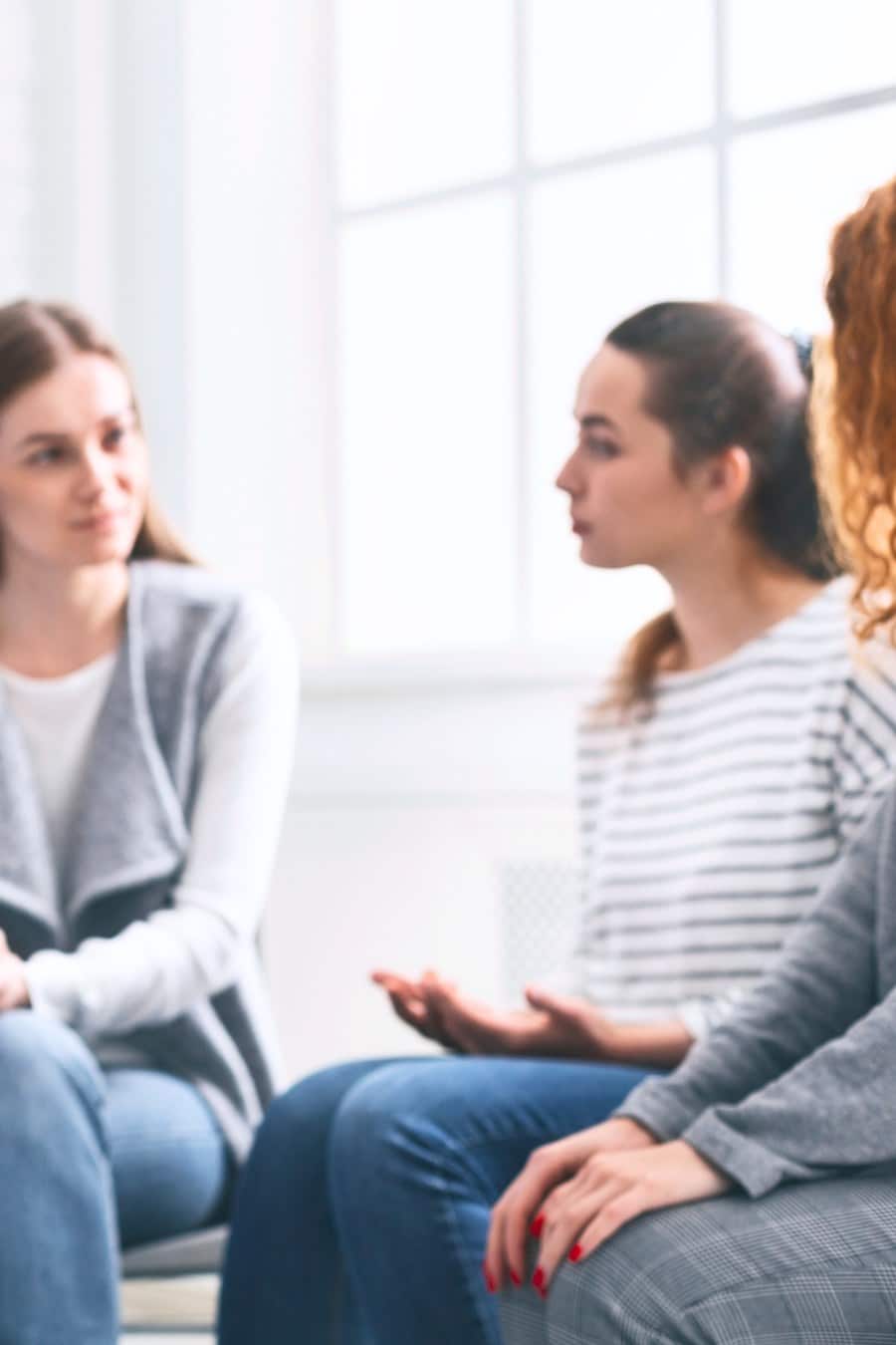 Depressed man sitting at rehab group therapy