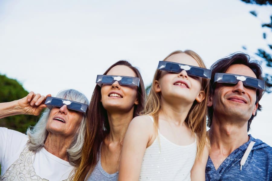 Family looking at Solar Eclipse using solar glasses