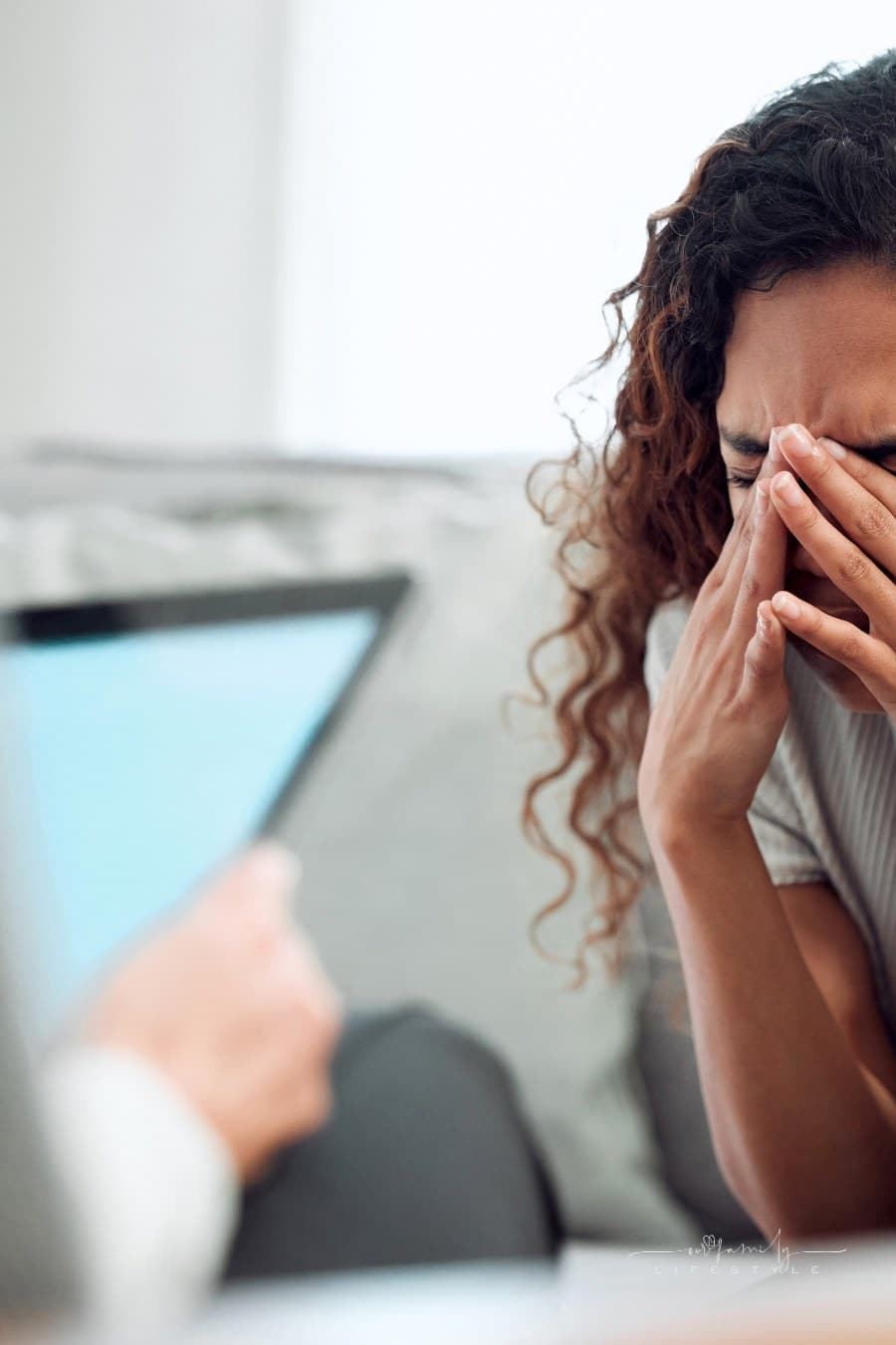 Shot of an attractive young woman sitting and feeling stressed during her consultation with her psychologist.