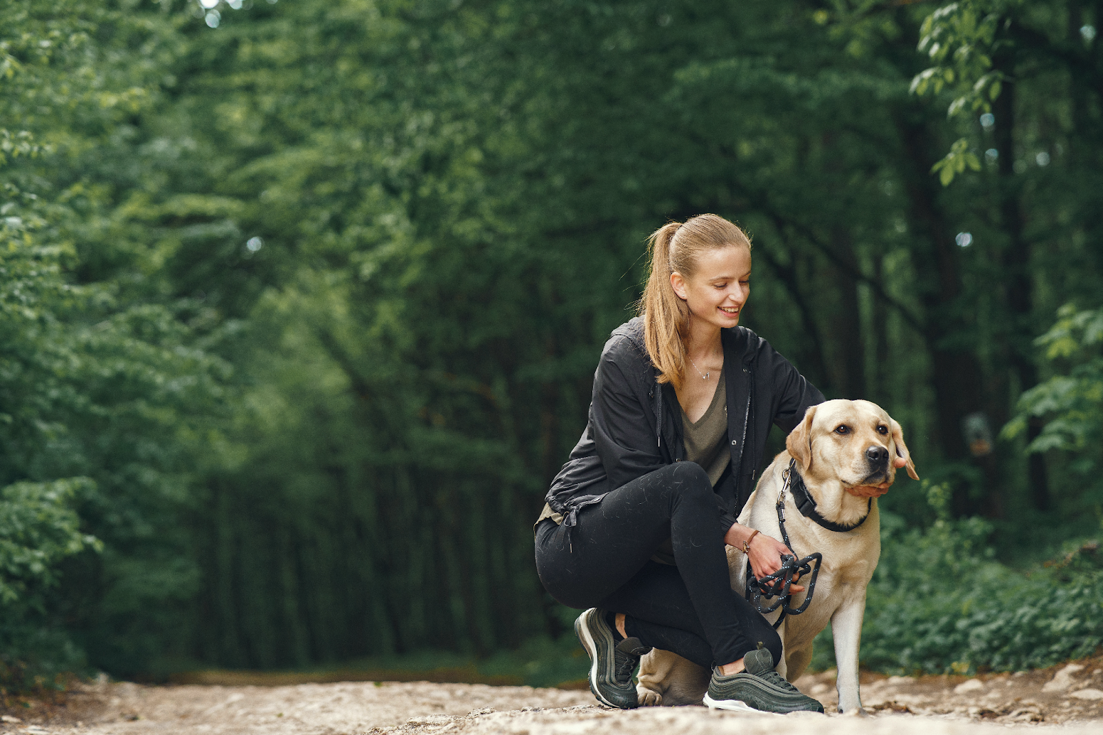 A woman with a dog in the forest