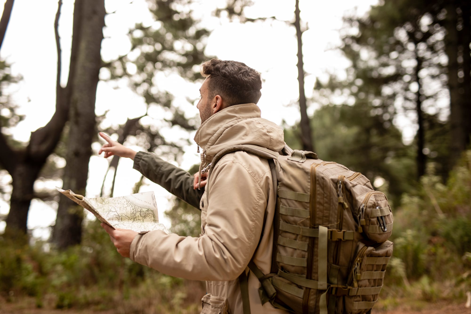 medium-shot-guy-pointing-something while wearing a tactical backpack