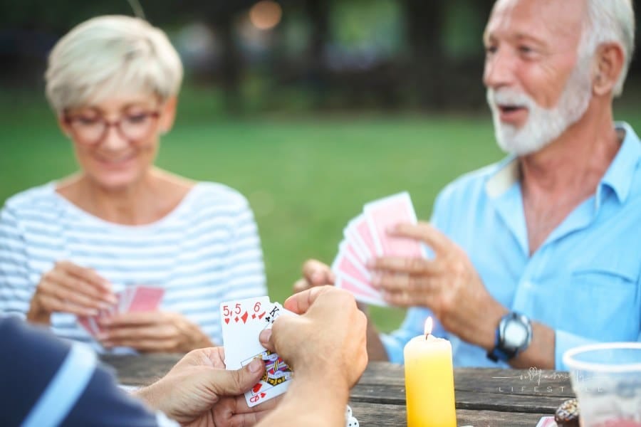 Senior people playing card game
