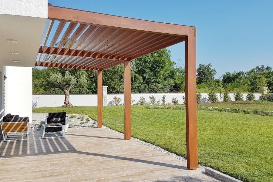 pergola anchored on concrete and attached to a house