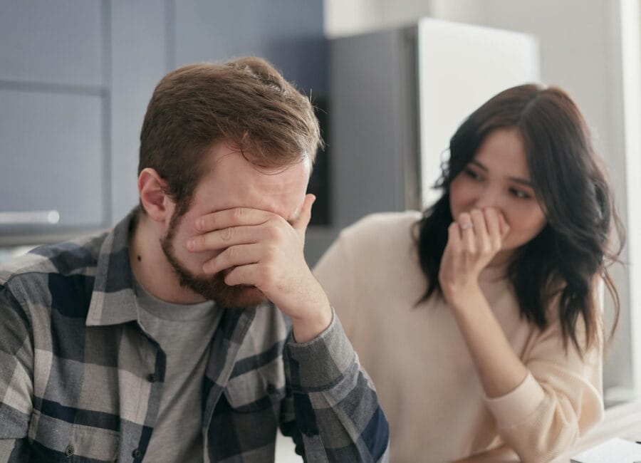 A distraught couple indoors, showing stress and concern, fostering empathy.