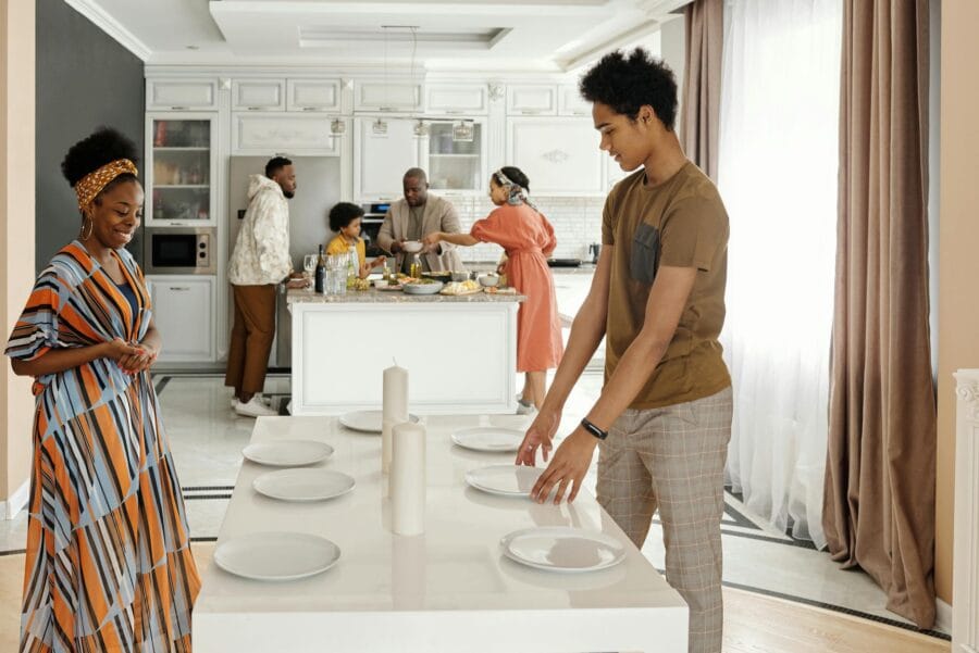 A joyful family gathers to prepare a meal in a bright, modern kitchen setting, celebrating togetherness.