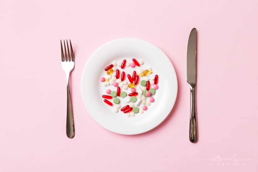 weight loss pills and supplements on white plate