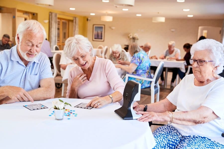 Group of Seniors Playing Game of Bingo in Assisted Living Home