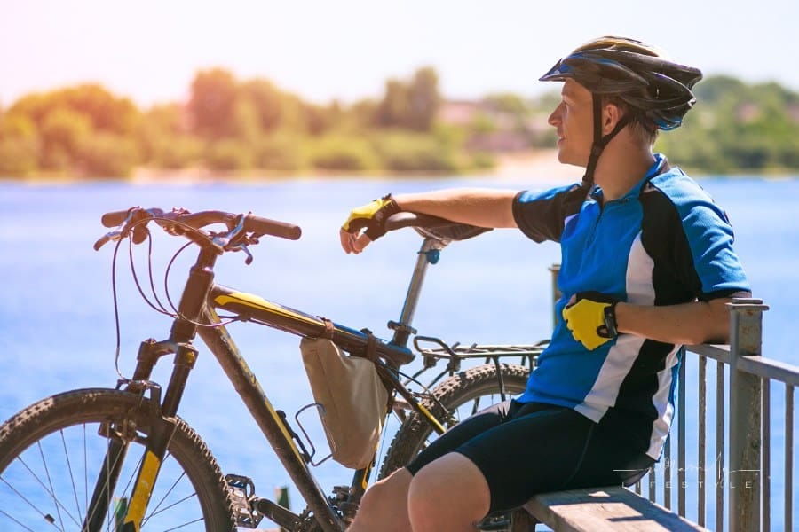 Bicyclist relaxing with bike on a Sunny summer day
