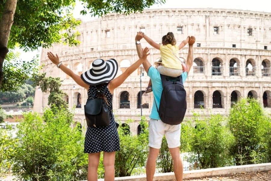 young family in front of Colosseum in Rome, Italy