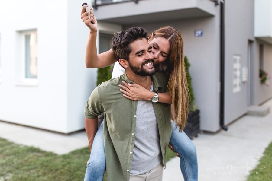 couple celebrating with keys to new house