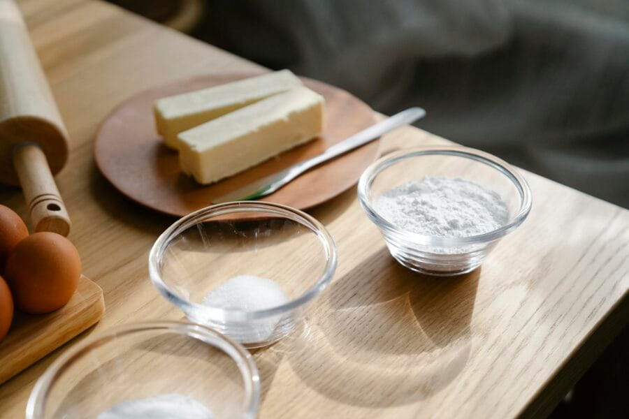 Close-up of baking ingredients on a wooden table with natural lighting.