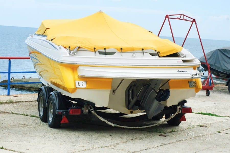 Yellow Covered Boat on a Trailer