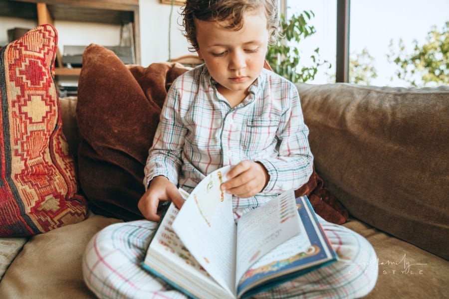 young boy reading a book
