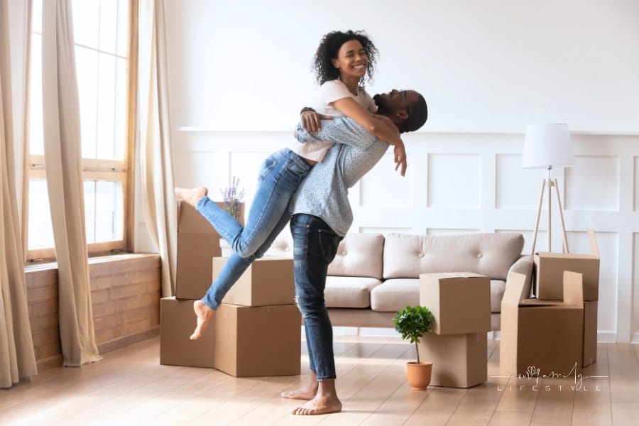 Happy couple first time home buyers celebrate moving day