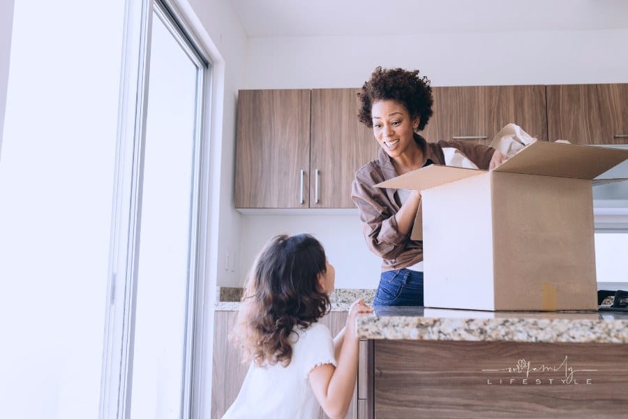 Woman and Child Packing Moving Boxes