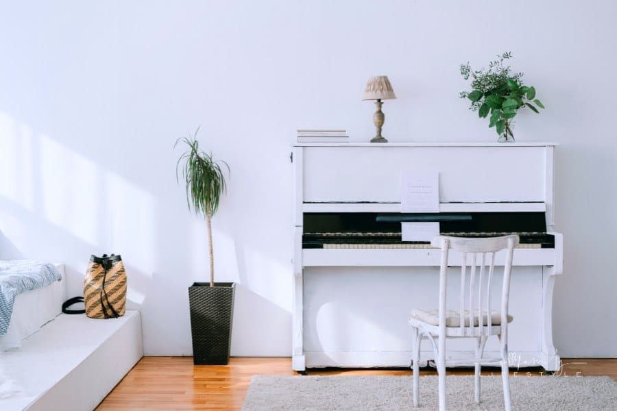 white piano in bedroom