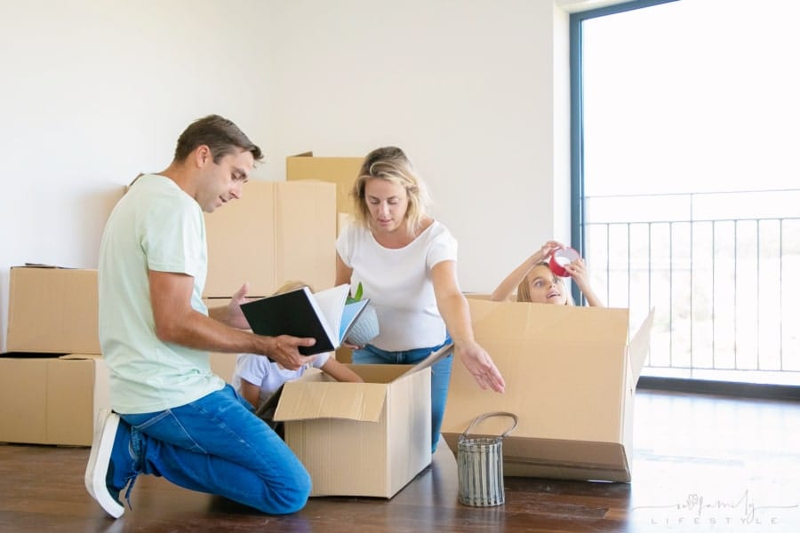 family packing boxes to move