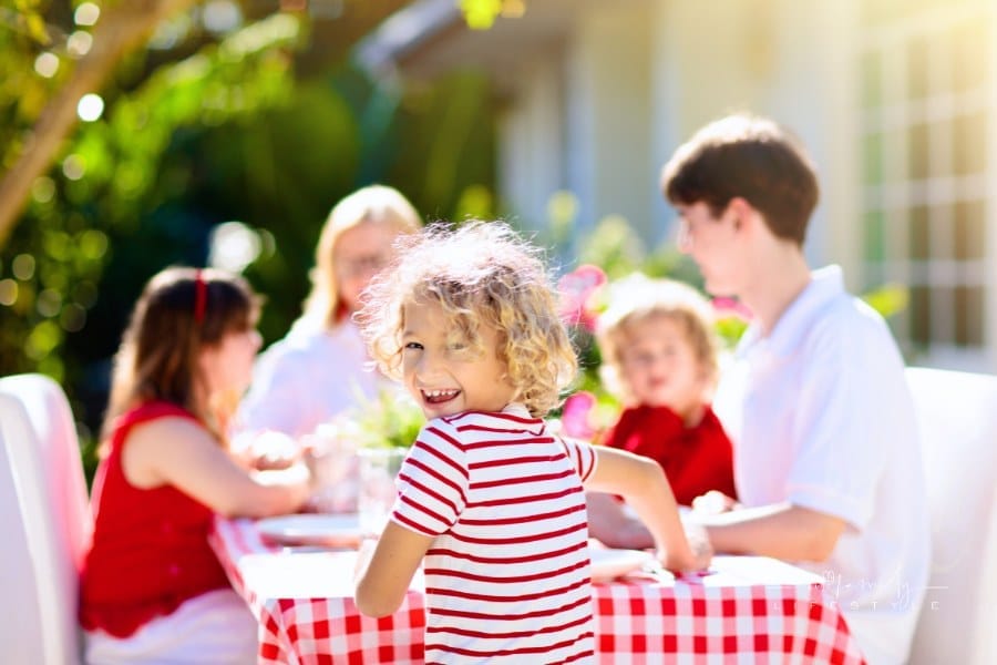 Family eating outdoor. Garden summer fun.