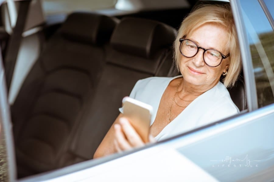 Senior Woman Using Phone in the Car