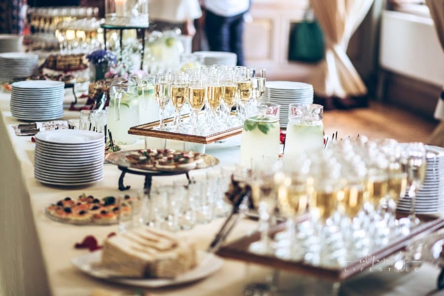 stylish champagne glasses and food appetizers on table at wedding reception. luxury catering at celebrations. serving food an